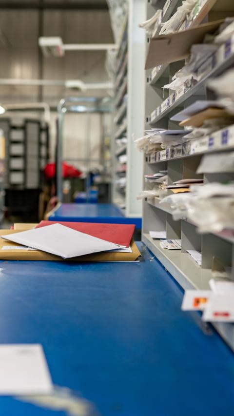 Post lying on a conveyor belt.