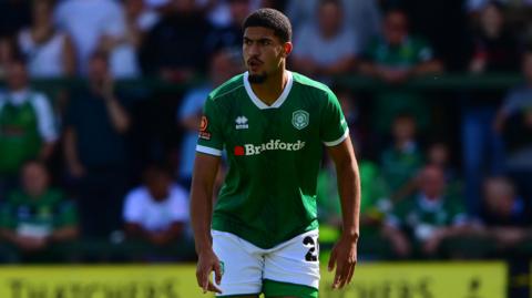 Raphael Araoye standing on the pitch during a game for Yeovil
