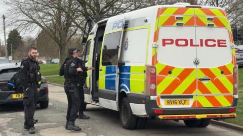 Leicestershire police armed officers at the door of a police van at Aylestone Road in Leicester.
