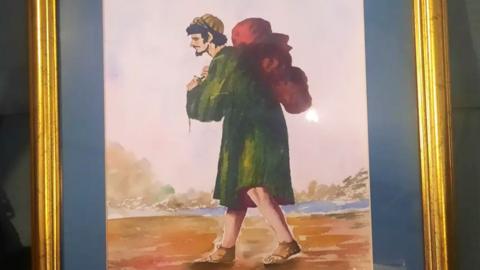 Dick Scott's painting, of a man in a green robe carrying a red bag on his back, inspired by Francisco de Zurbarán's 17th-century portraits Jacob and his Twelve Sons