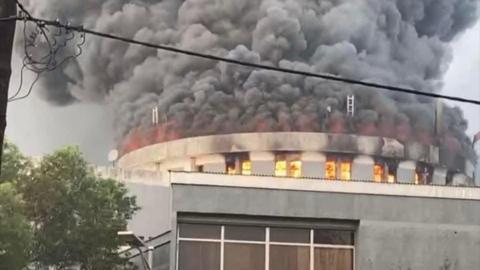 Thick smoke billows from Liberia's Capitol building. Flames can also be seen.