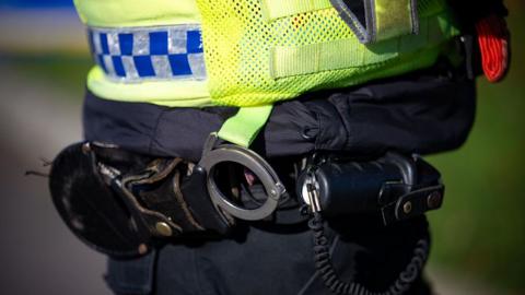 A stock photo of a police officer's handcuffs.