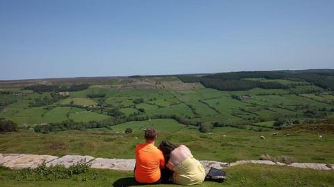 A couple enjoy the view over the North Yorkshire Moors