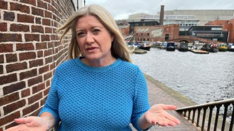 A close-up shot of BBC's Kathryn Stanczyszyn wearing a blue jumper.
