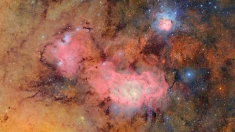 The pink, blue and orange clouds of gas and dust that make up the Trifid nebula and the Lagoon nebula.