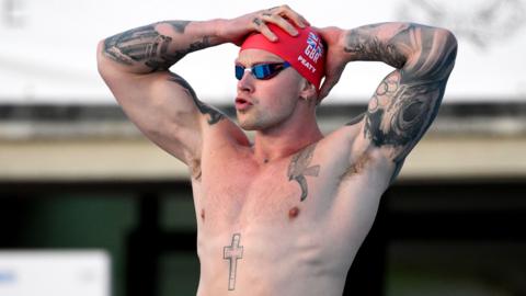 Adam Peaty on the blocks preparing to race