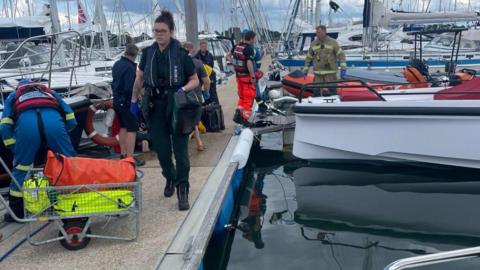 Emergency services at scene of boat explosion and fire