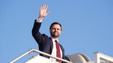 US Vice President JD Vance waves as he boards Air Force Two after attending talks on Iran in Islamabad .