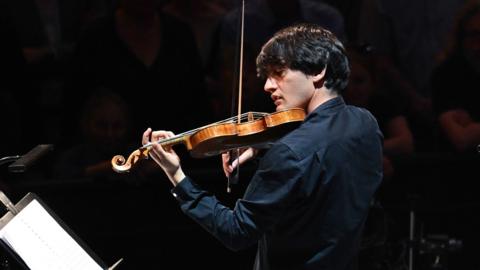 A man playing the violin