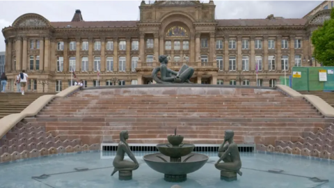 The council house and square can be seen behind a fountain with figurines in and the Floozy in the Jacuzzi at the top of the water feature.
