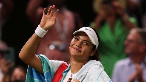 Emma Raducanu waves to the Wimbledon crowd