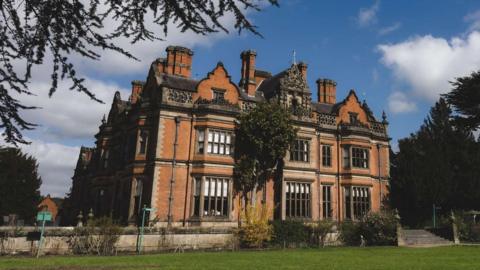 A view of a stately home building including the ornate chimney stacks which have been deemed unsafe