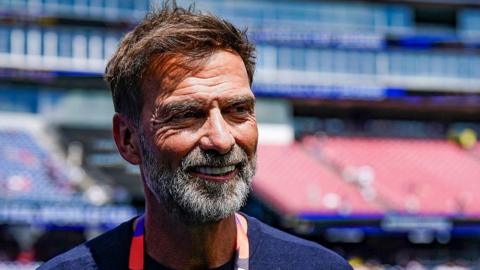 Head and shoulders view of Jurgen Klopp, with brown hair and grey beard, and blue T-shirt