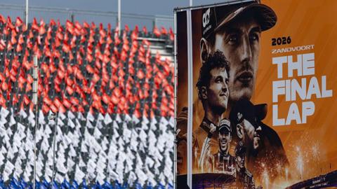 Individual flags are laid out on each seat of the grandstand to create a larger image of the Dutch flag with the race poster