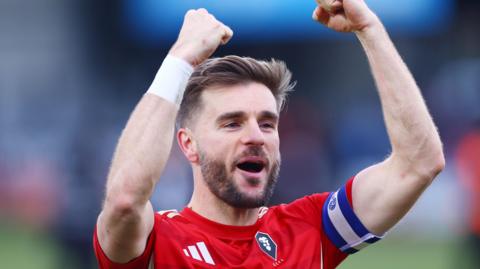 Luke Garbutt celebrating Salford City's win against Colchester United
