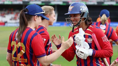 Smriti Mandhana is congratulated by her Manchester Super Giants team-mates