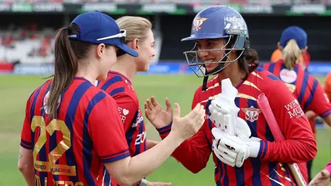 Smriti Mandhana is congratulated by her Manchester Super Giants team-mates