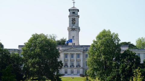 A front view of the Trent Building on University Park campus, from across the Highfields Lake.