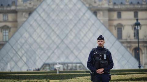  Police stand guard outside the Louvre museum at Louvre on October 19, 2025 in Paris, France.