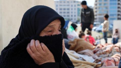 Displaced people sit beneath a statue at Martyrs' Square in Beirut, Lebanon (3 March 2026)