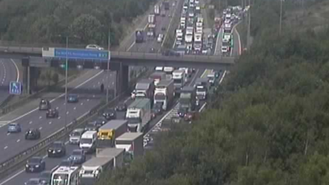 Lots of cars and lorries in a jam on a motorway