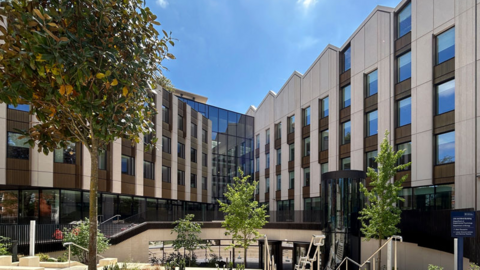 A CGI mock-up of the new centre. It is a modern building with a large white brown and glass façade.