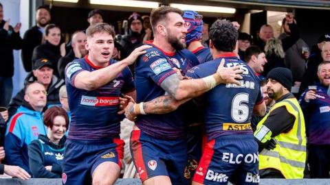 Kyle Feldt (centre) celebrates his try for St Helens at Wakefield Trinity