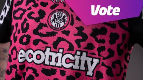 a close up of forest green rovers' away kit which is a bright pink and covered in black splotches - the forest green rovers crest is featured in the centre and text reading vote in the top right hand corner of the image.