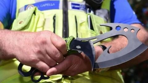 A police officer holding a knife