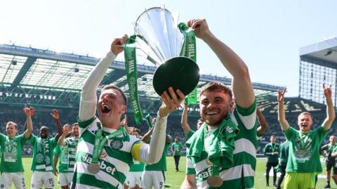 Callum McGregor and James Forrest lift the Scottish Premiership trophy in May