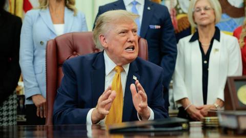 US President Donald Trump speaks to the media after signing an executive order establishing the President's Military Spouse Commission in the Oval Office at the White House on August 03, 2026 in Washington, DC.