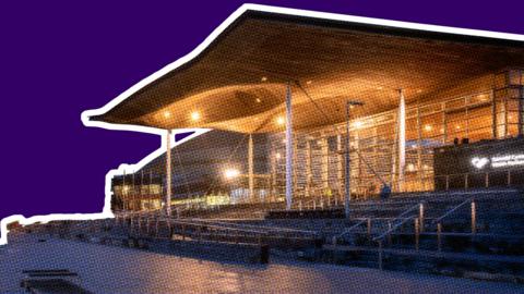 The Senedd building in Cardiff Bay, at night, against a red graphic background