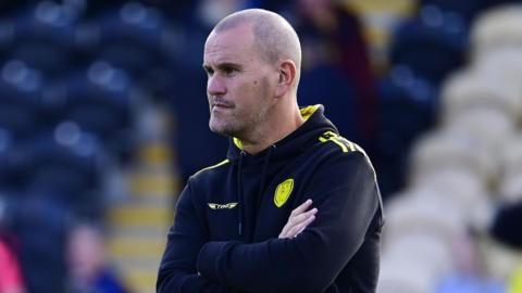 Former head coach Mark Robinson watching a Burton Albion game from the touchline