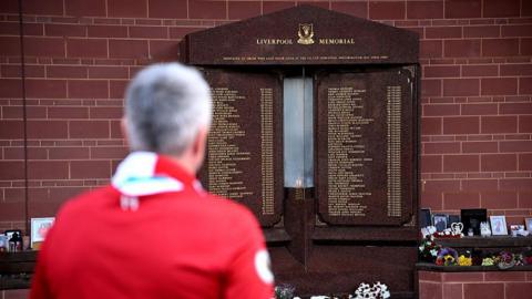 A fan of Liverpool pays their respects at the Hillsborough Memorial ahead of the 36th anniversary of the disaster, prior to the Premier League match between Liverpool FC and West Ham United at Anfield on 13 April, 2025.