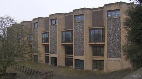 The outside of Winchester Crown Court on a cloudy grey day.
