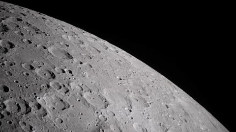 A cratered section of the moon is seen close-up