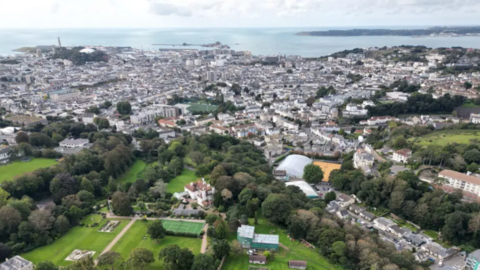 St Helier aerial shot with properties, buildings and green areas