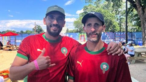 Ayoub Baghdad is wearing a red jersey from the Moroccan national team.