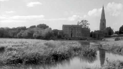 A church and mill alongside a stream.