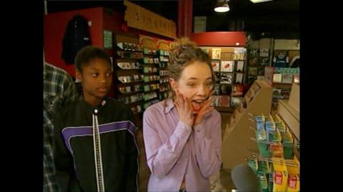 Two teenage girls standing in a music store.