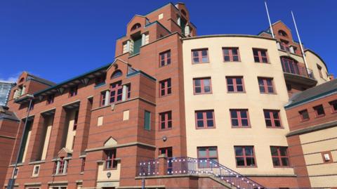 Leeds Magistrates' Court, a red-brick building with a cream-coloured brick section.
