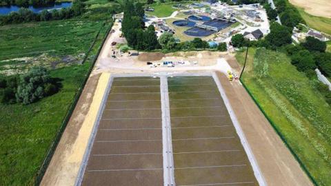 Aerial photograph of the Cirencester Sewage Treatment site. The new filtration bed can be seen, as well as buildings in the distance. 