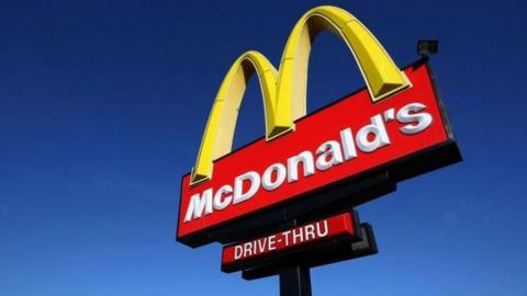 A large sign which has McDonald's golden arches above the word "McDonald's" and "drive-thru".