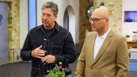 John Torode, left, and Gregg Wallace standing in a kitchen