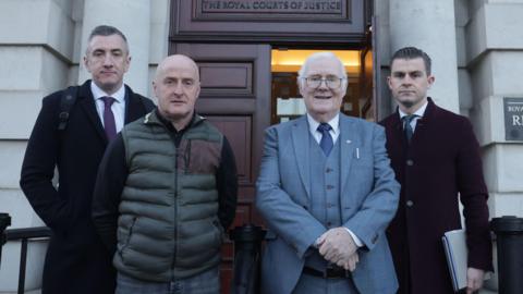 From right to left: Darragh Mackin from Phoenix Law, Eugene Reavey, Brendan Farmer and Gavin Booth from Phoenix Law appeared at Belfast High Court on Friday. The two men stand in the middle, with Mr Mackin and Mr Booth from Phoenix Law standing either side. 