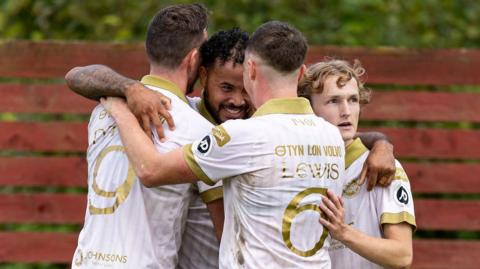 Dominic Smith of Caernarfon Town celebrates scoring his sides fourth goal.