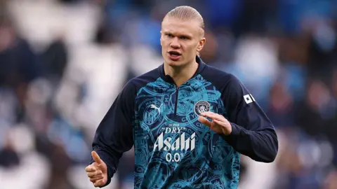 Erling Haaland of Manchester City reacts as he warms up 
