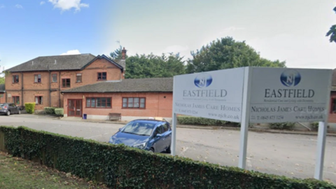 A google maps image of the Eastfield Care Home in Maidstone, Kent. The red-brick building has a two-floor section and a single floor section. A white sign for the facility can be seen on the right-hand side of the image.