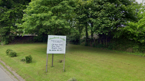 Sign outside Woodlands Lodge Care Home in Barnsley