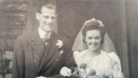 A picture of Jim and Nellie Reynolds on their wedding day in 1947. It is black and white.